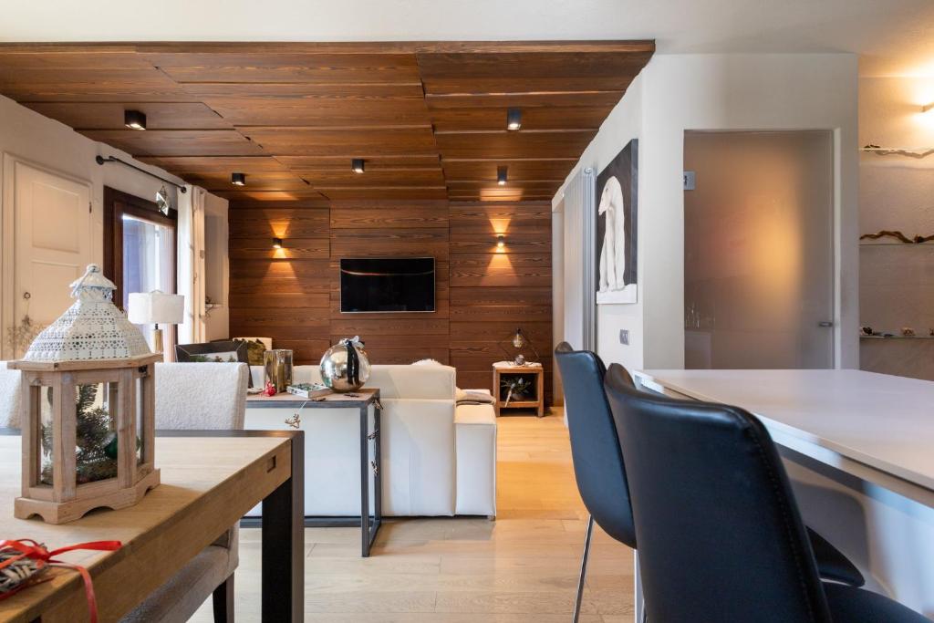 a kitchen and living room with a table and chairs at Luxury Lodges by Grand Hotel Sitea in Sestriere