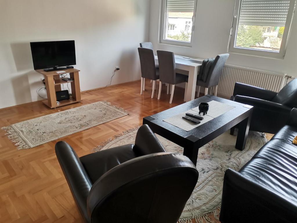 sala de estar con mesa y sillas en Nikolici - Free Parking en Vranje