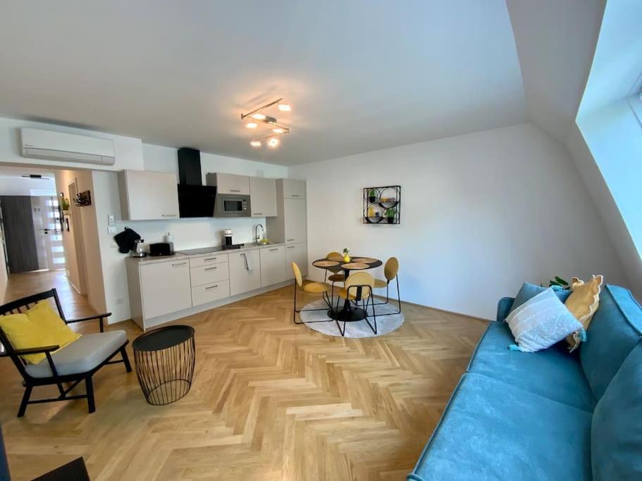 a living room with a blue couch and a table at Freshly renovated Apartment in Trendy Area! HG21 in Vienna