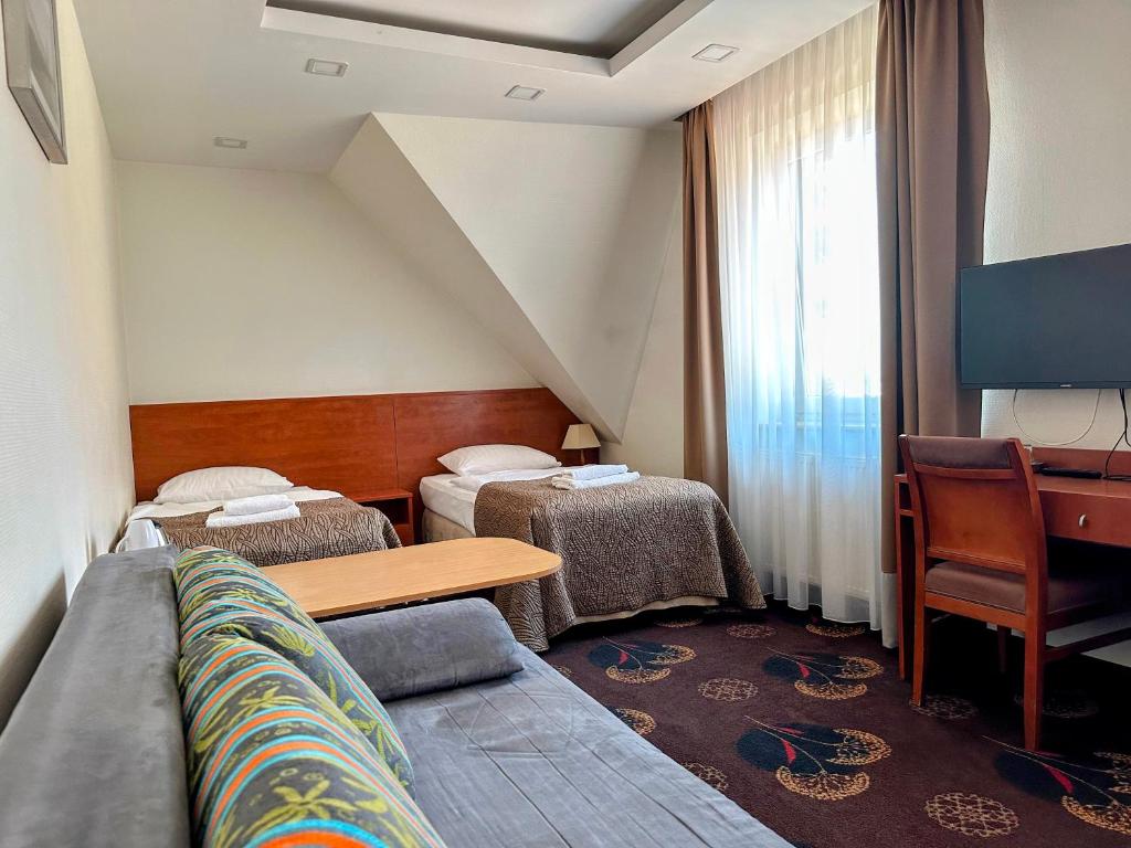 Postel nebo postele na pokoji v ubytování Akme APARTMENTS & ROOMS & FREE PARKING