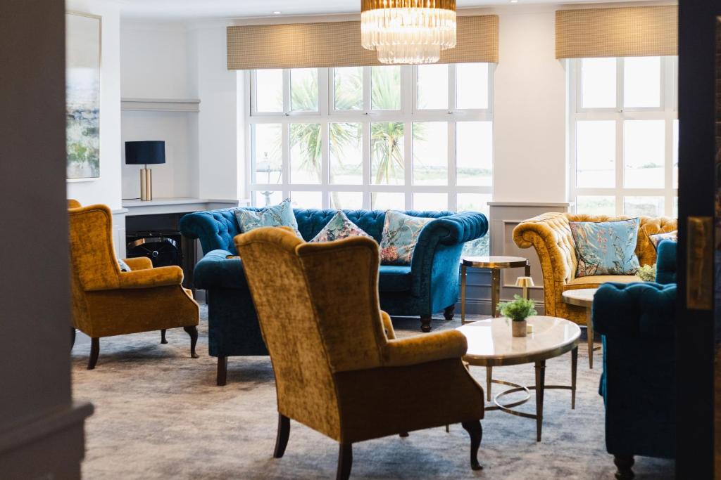 a living room with blue couches and chairs at Gray's at Bushmills in Bushmills