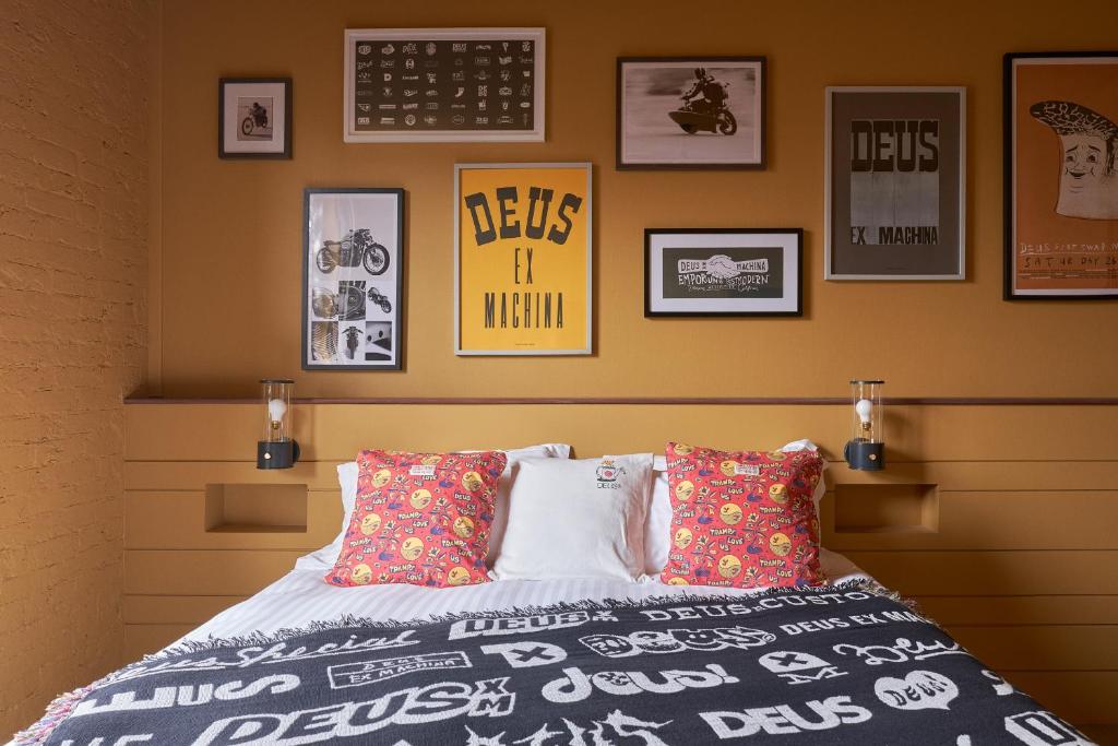 a bedroom with a bed and pictures on the wall at Deus Lodge of Heavy Leisure in Bournemouth