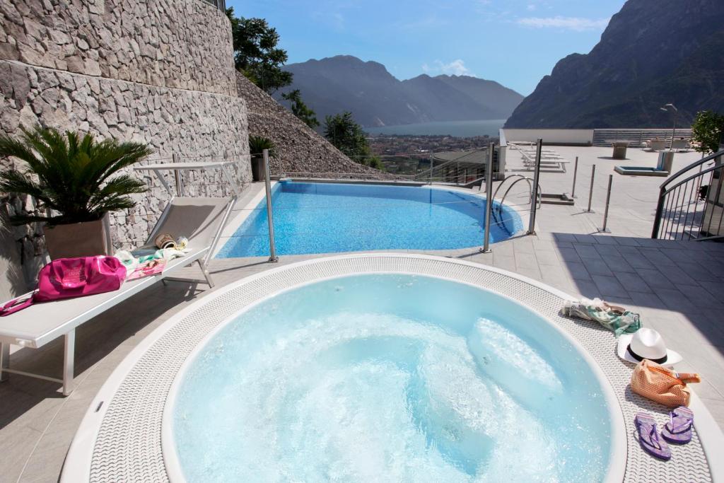 a jacuzzi tub with a view of the mountains at Agritur Acetaia Gourmet&Relax in Tenno
