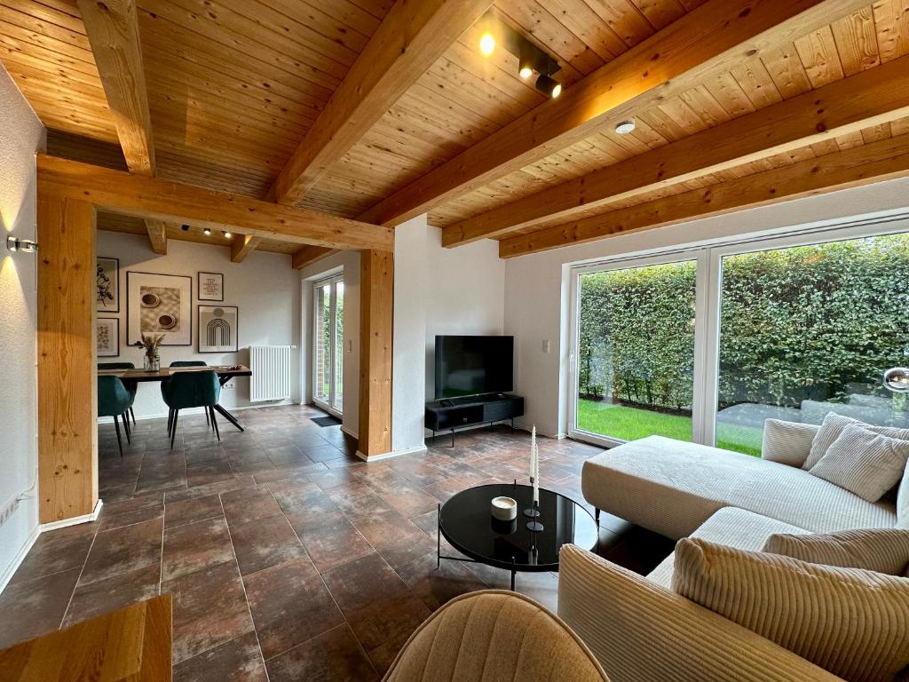 a living room with a couch and a table at Ferienhaus Franke am Großen Meer in Südbrookmerland