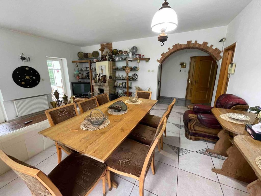 a dining room with a wooden table and chairs at Cabana Celesta in Predeal