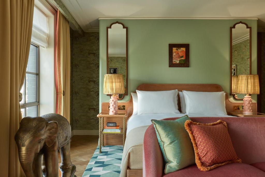 a bedroom with a bed and a couch at Broadwick Soho in London