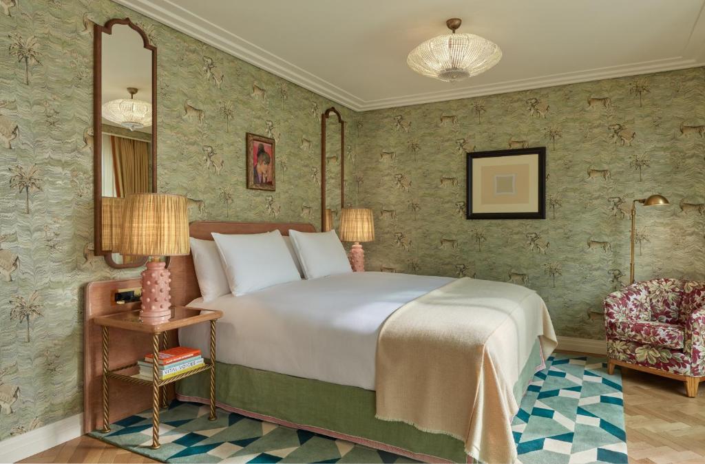 a hotel room with a bed and a chair at Broadwick Soho in London