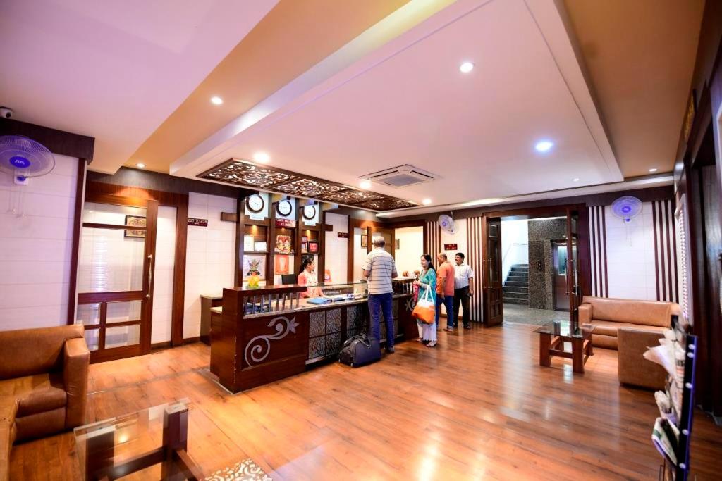 a group of people standing in a hotel lobby at Hotel Jataka Inn in Bodh Gaya