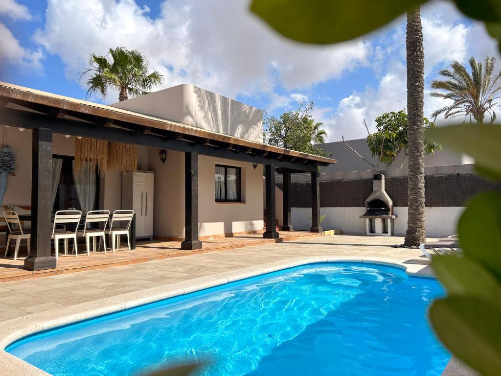 een villa met een zwembad voor een huis bij Boho Palm in Corralejo