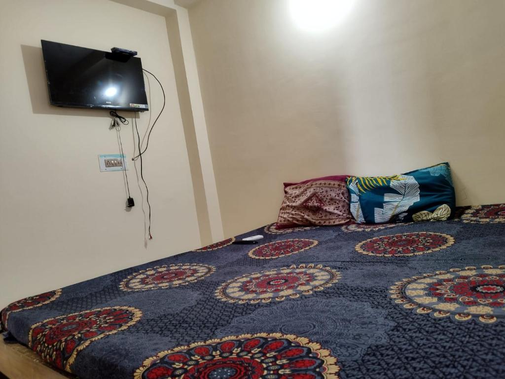 a bedroom with a bed with a rug on it at HOTEL 7s in Puri