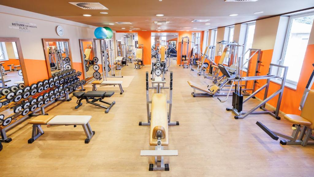 a gym with several treadmills and exercise machines at Hotel Neptun - Terme & Wellness Lifeclass in Portorož