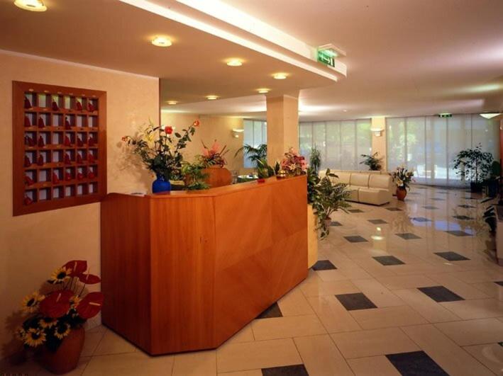 a lobby with a reception desk in a building at Hotel Bella Romagna in Rimini