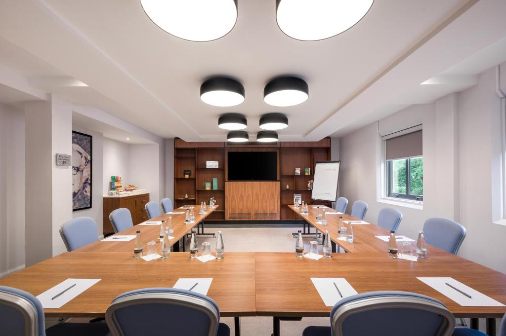 a large conference room with a long table and chairs at Courtyard by Marriott Glasgow Airport in Paisley