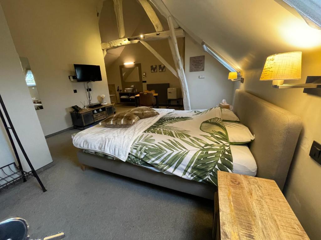 Postel nebo postele na pokoji v ubytování De Verborgen Parel B&B