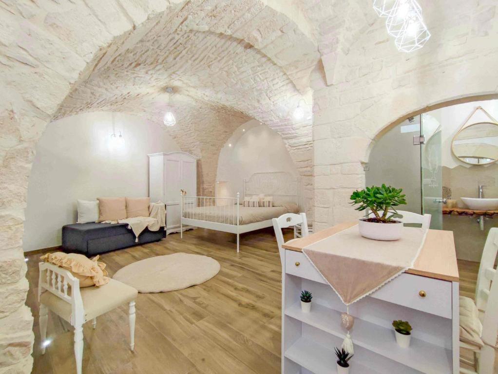 una gran sala de estar con una pared de piedra. en Maison Chloe Perla Blanche, en Martina Franca