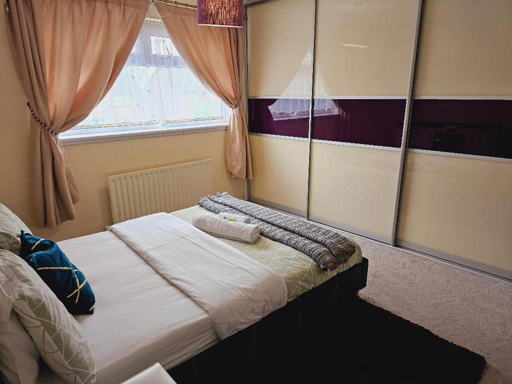 a bedroom with a bed with two towels on it at Haven Home in Bristol