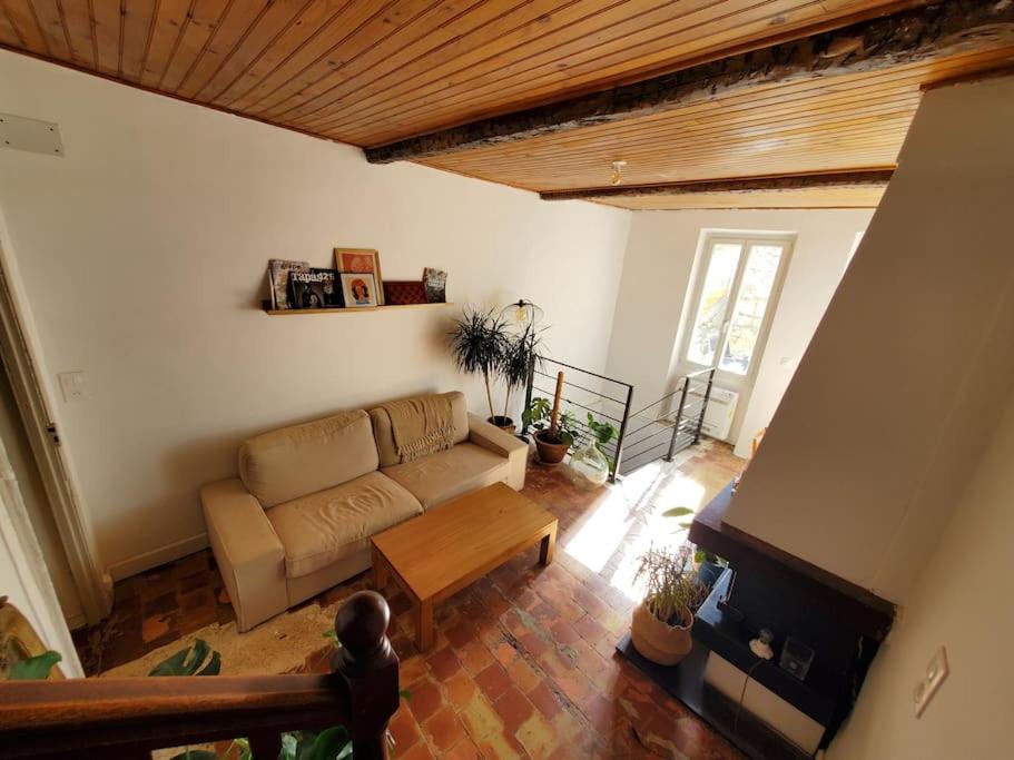 a living room with a couch and a table at Le Bohème in Sigean