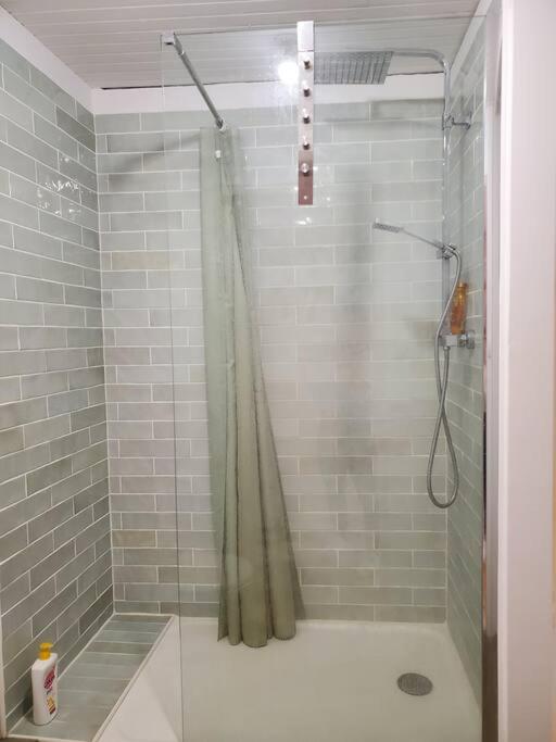 a bathroom with a shower with a shower curtain at Le Bohème in Sigean