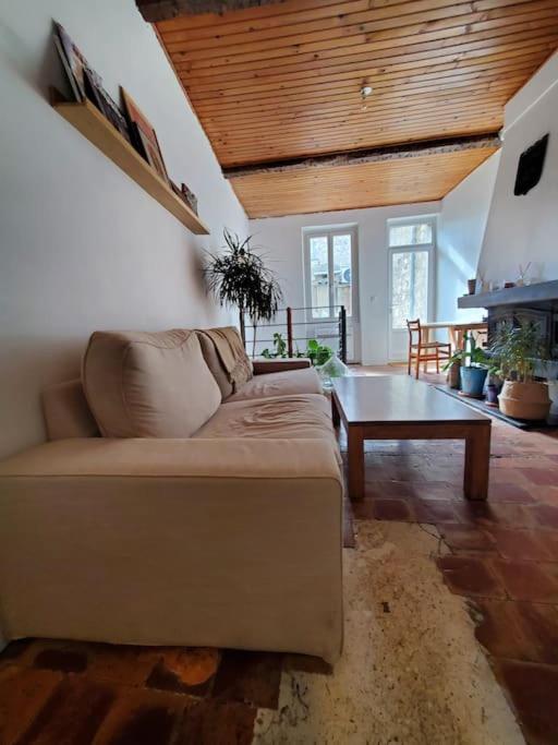 a living room with a couch and a table at Le Bohème in Sigean