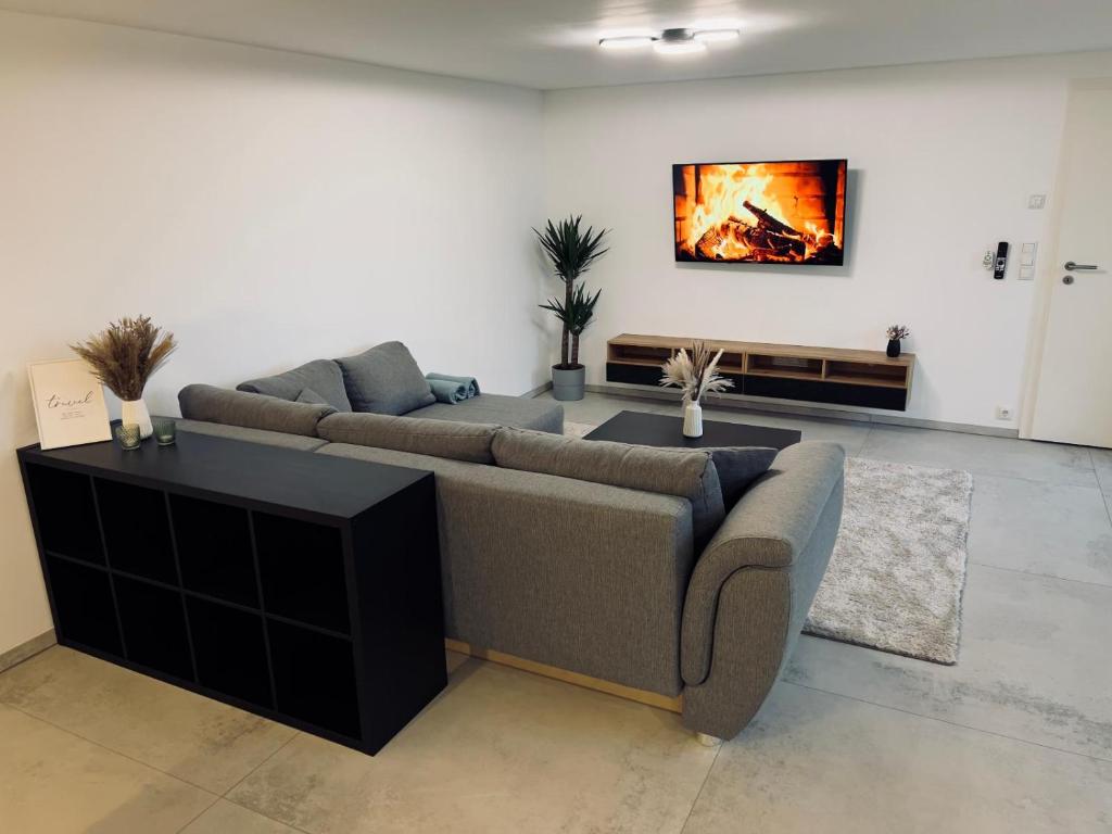 a living room with two couches and a painting on the wall at Ferienwohnung Traum am Berg in Zwiesel