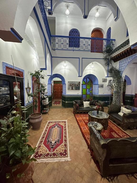 a large living room with blue and white at Riad Assalam in Marrakech