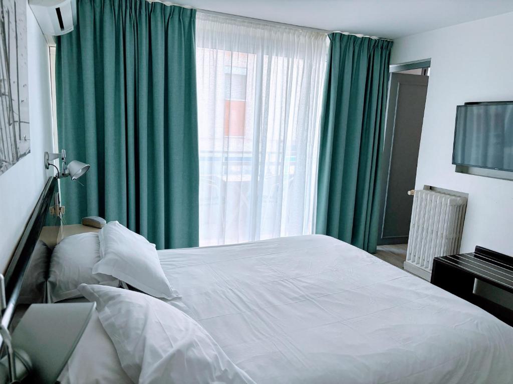 Postel nebo postele na pokoji v ubytování Brasilia Hôtel