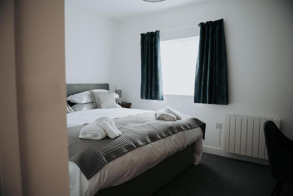 a bedroom with a bed with towels on it at The Fox and Hounds in Banc-y-felin