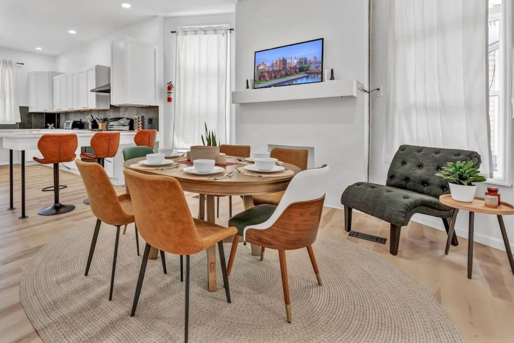 a kitchen and dining room with a table and chairs at Trendy Two-Level Apartment in Buffalo