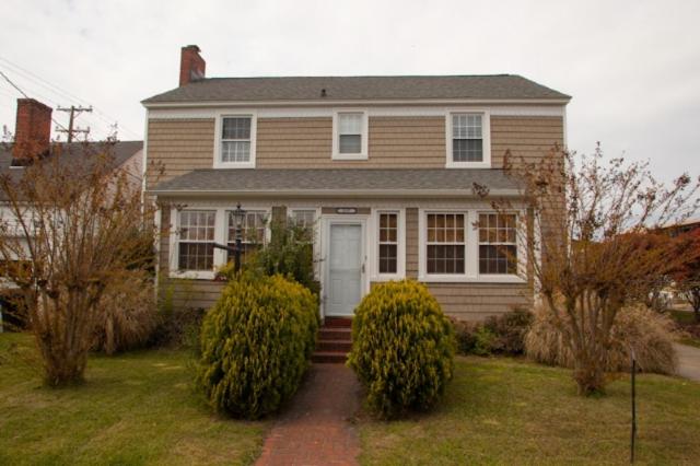 a house with a white door in a yard at Sea Dog - Resort Area VB in Virginia Beach