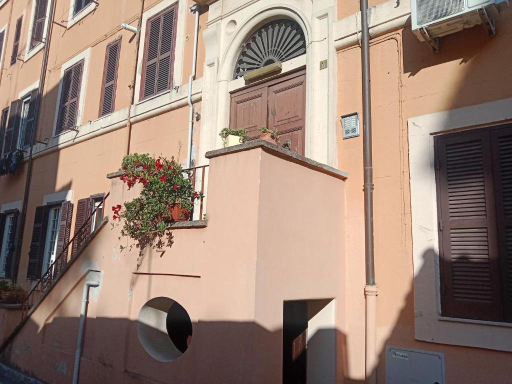 a building with a door and a balcony with flowers on it at Dall' olimpico all auditorium in Rome