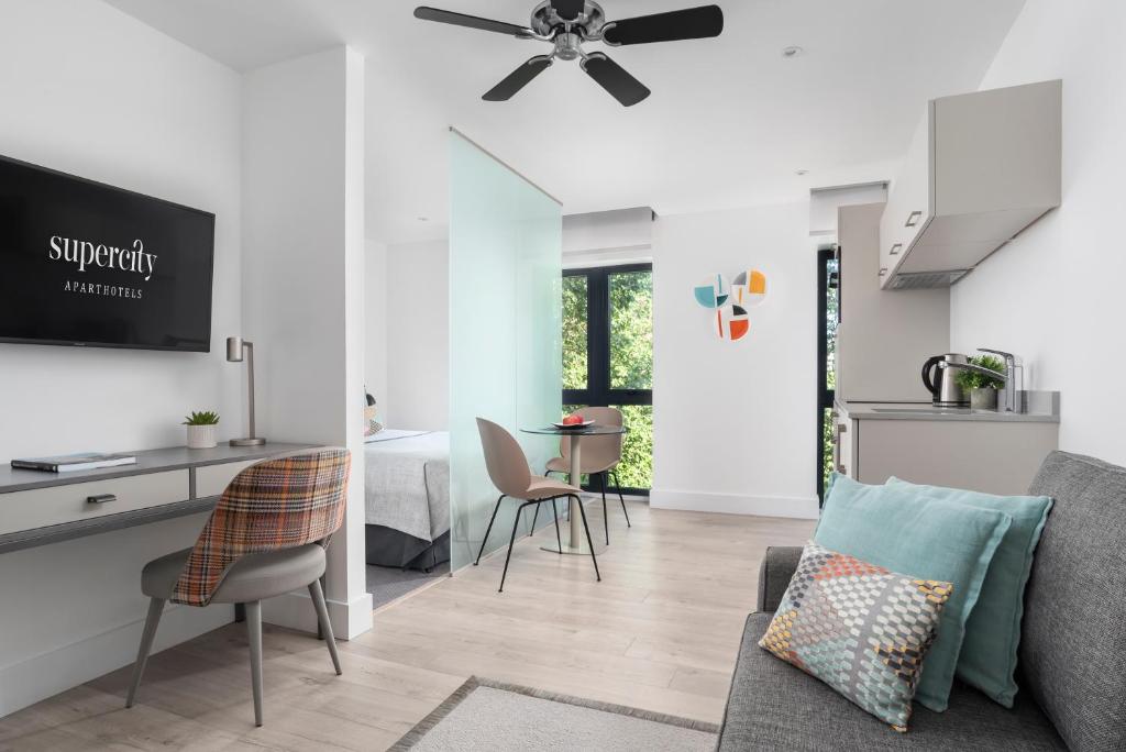 a living room with a couch and a table at Q Square by Supercity Aparthotels in Brighton & Hove