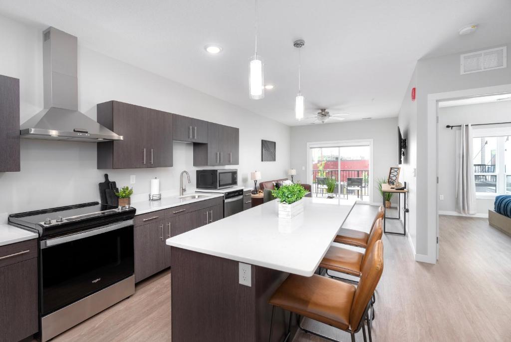 a kitchen with a white counter top and a table at Lincoln Park Boutique Hotel in Duluth