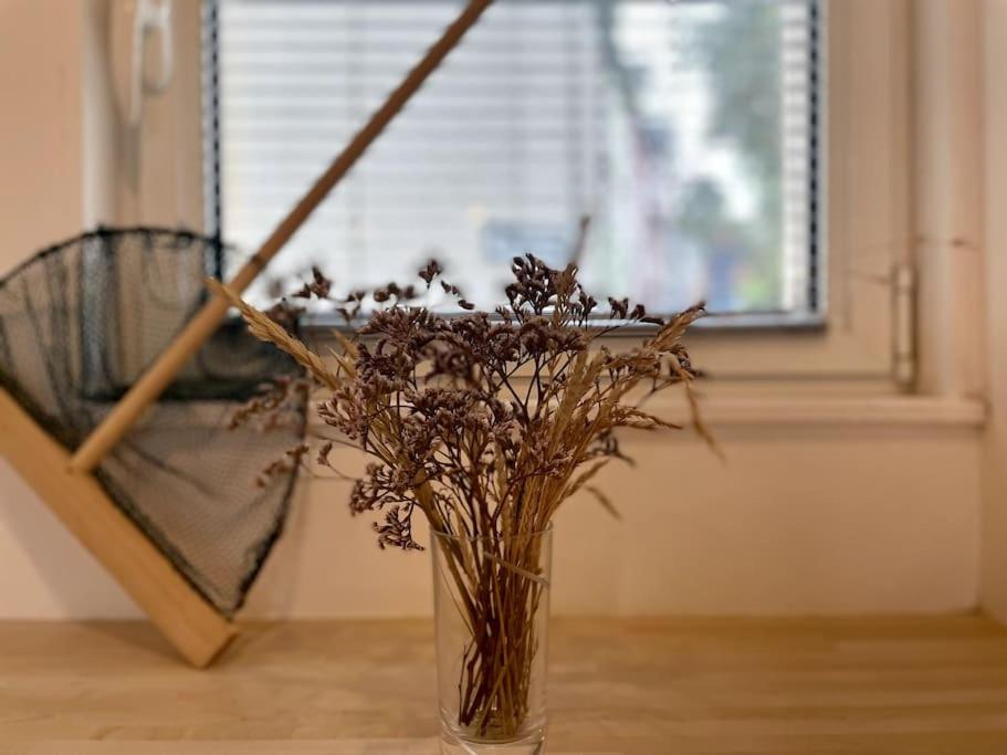 a vase filled with dried flowers sitting on a table at Le Belvédère de la Baie, grand gîte pour deux in Saint-Valéry-sur-Somme