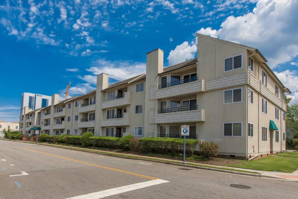 an apartment building on the side of a street at The Beacon at Playa Rana in Virginia Beach
