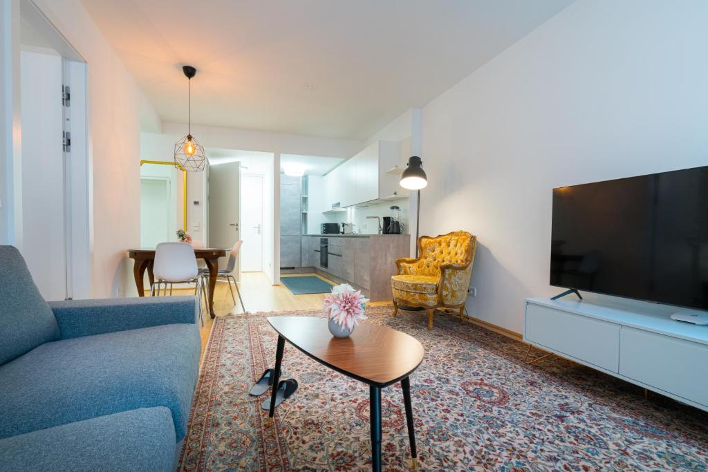 a living room with a couch and a tv and a table at Vienna Residence, Vorgartenstraße - Leopoldstadt in Vienna