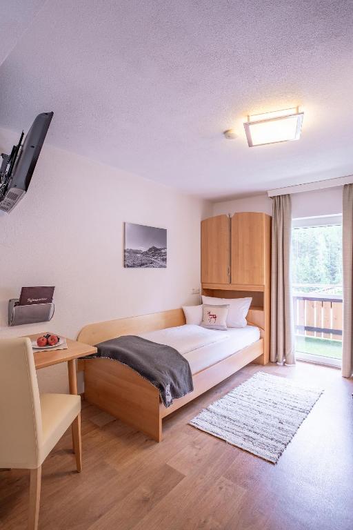 Postel nebo postele na pokoji v ubytování Patteriol Apart-Hotel-Garni