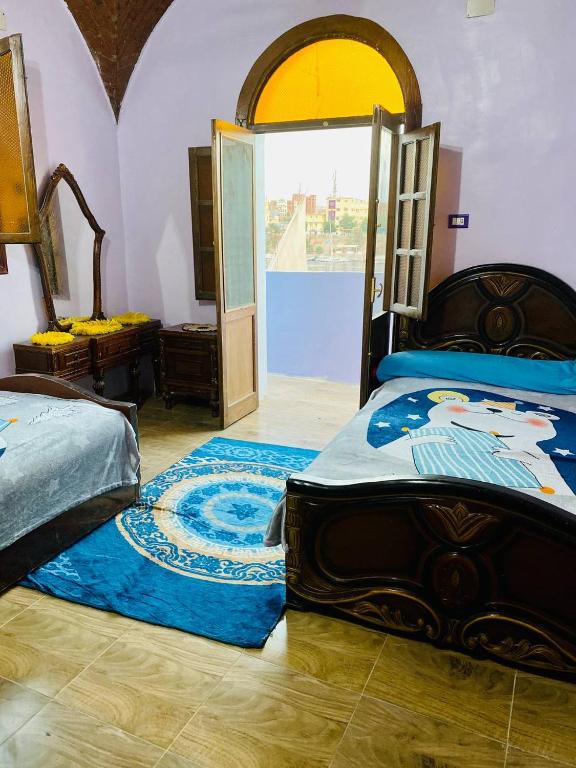 Postel nebo postele na pokoji v ubytování Malika nubian house