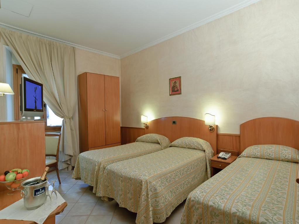 Postel nebo postele na pokoji v ubytování Hotel Museum