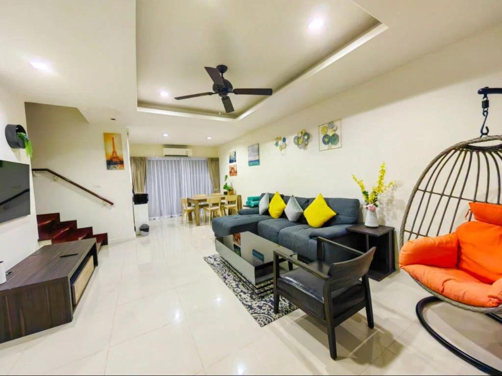 a living room with a blue couch and a bird cage at Laguna Park, BangTao Laguna in Bang Tao Beach