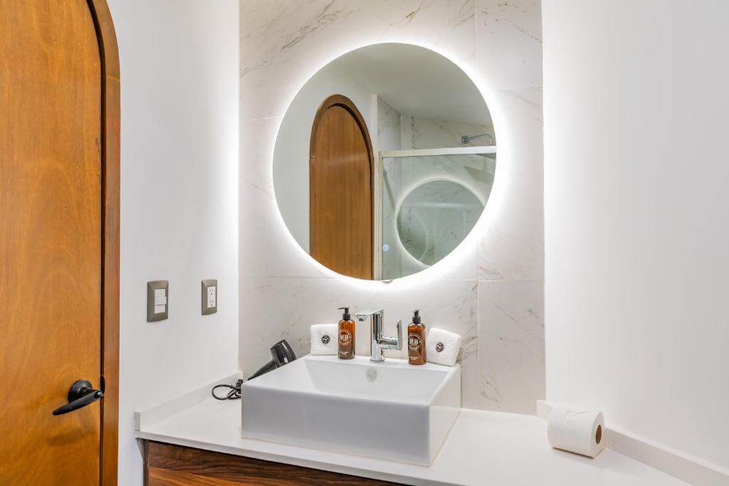 a bathroom with a sink and a mirror at Casa Castillo in Mexico City