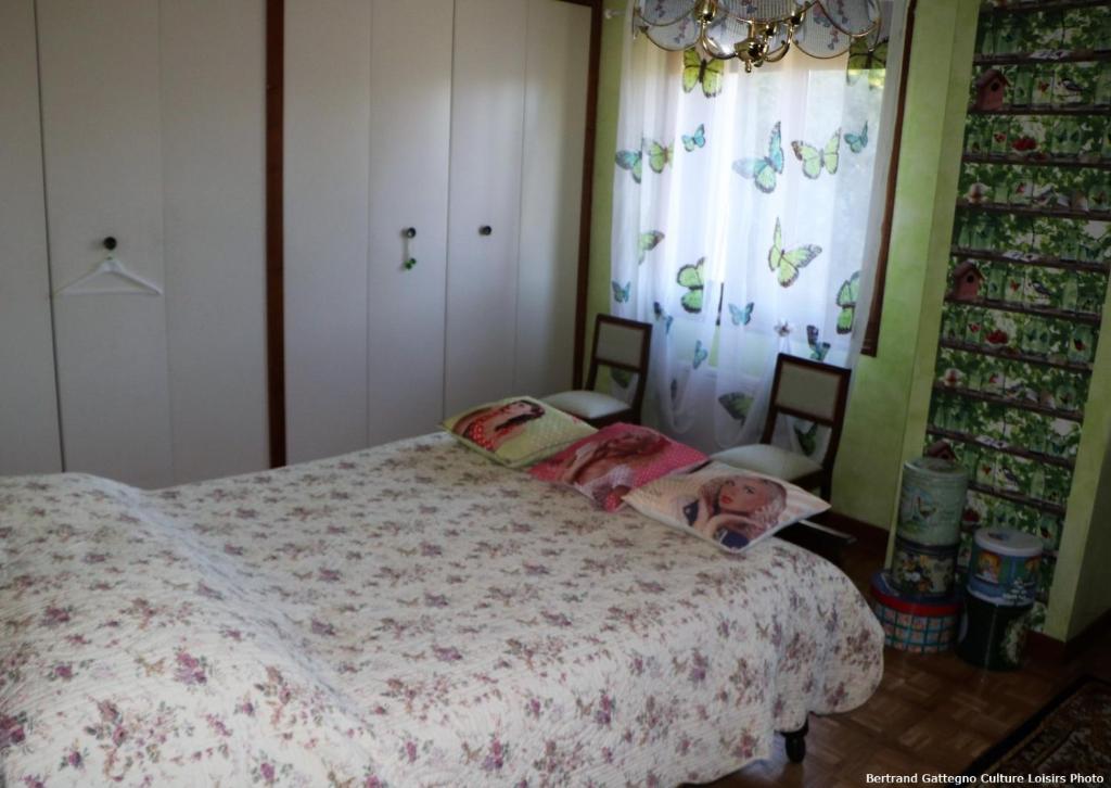 a bedroom with a bed with a doll on it at Horizon Aubrac Laguiole in Laguiole