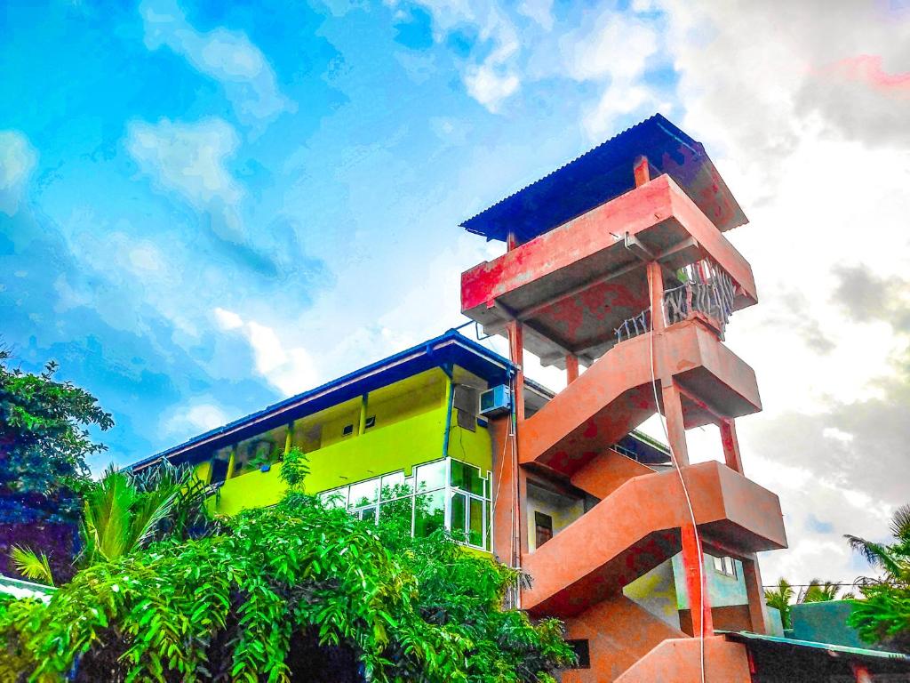 a multicolored building with a blue roof at Yala Bay Holiday Resort in Tissamaharama