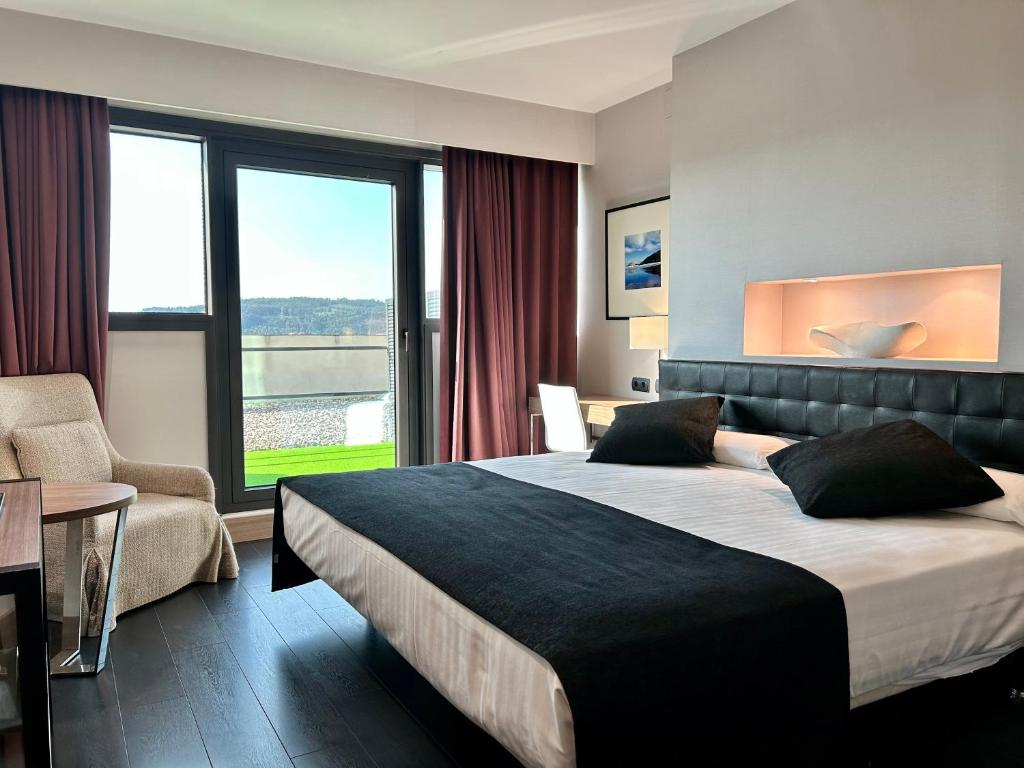 Postel nebo postele na pokoji v ubytování URH Hotel Spa Zen Balagares