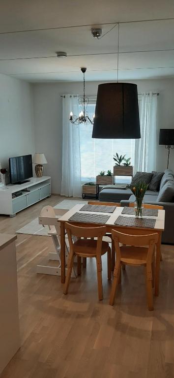 sala de estar con mesa y sofá en Pikiruukin helmi, en Kokkola