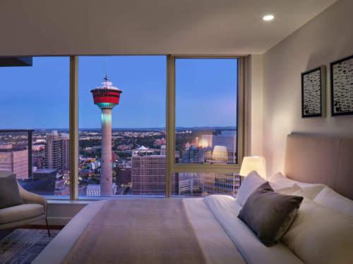 a bedroom with a bed with a view of a control tower at Award winning 1 bedroom apartment - extended stay in Calgary