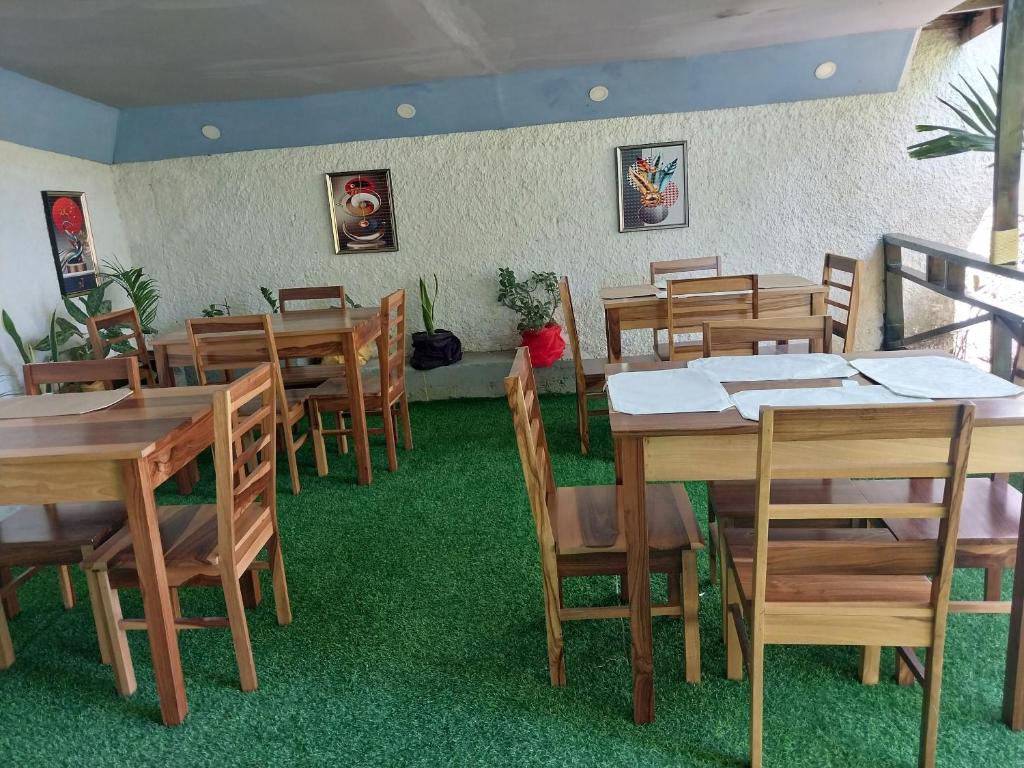 a dining room with wooden tables and chairs at The Aquaville Rush Apartment in Ocho Rios