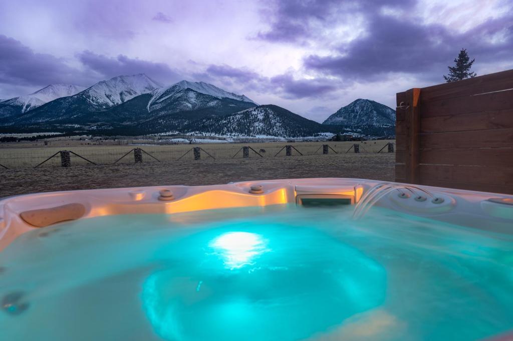 a hot tub with a view of snowy mountains at Buena Vista Mountain Retreat - Ultimate Privacy with Spa & Unbeatable Views in Buena Vista
