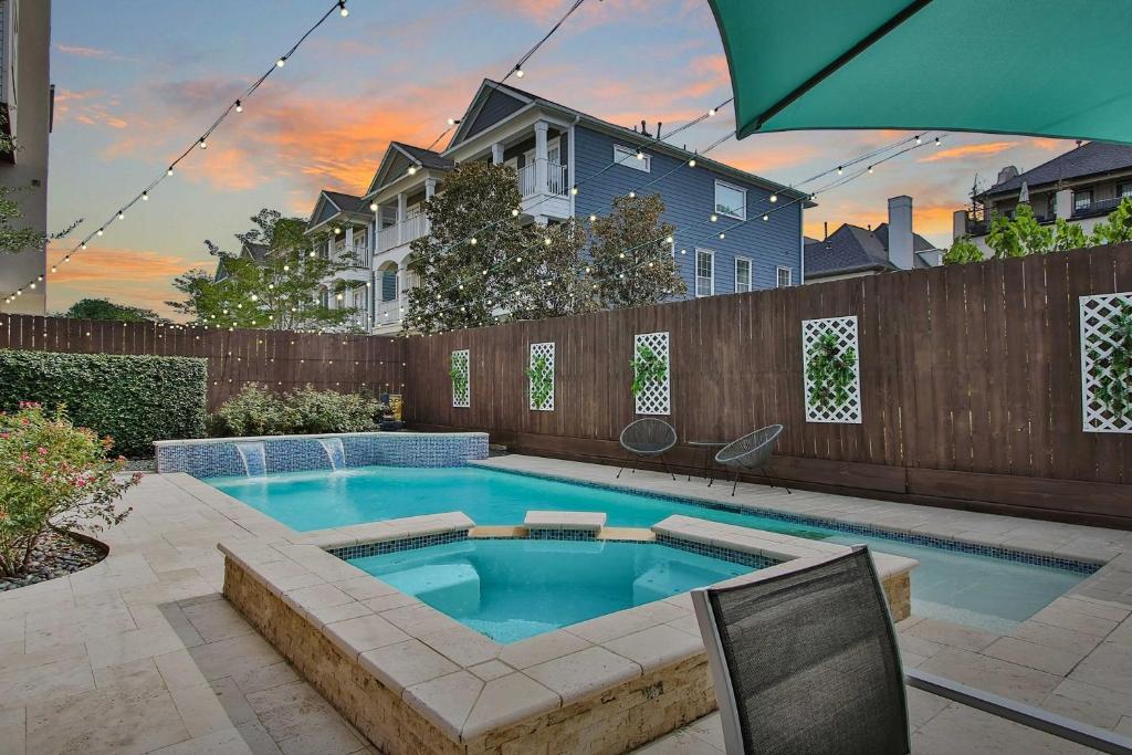 a swimming pool in the backyard of a house at Houston Home Near Downtown with Pool and Hot Tub! in Houston