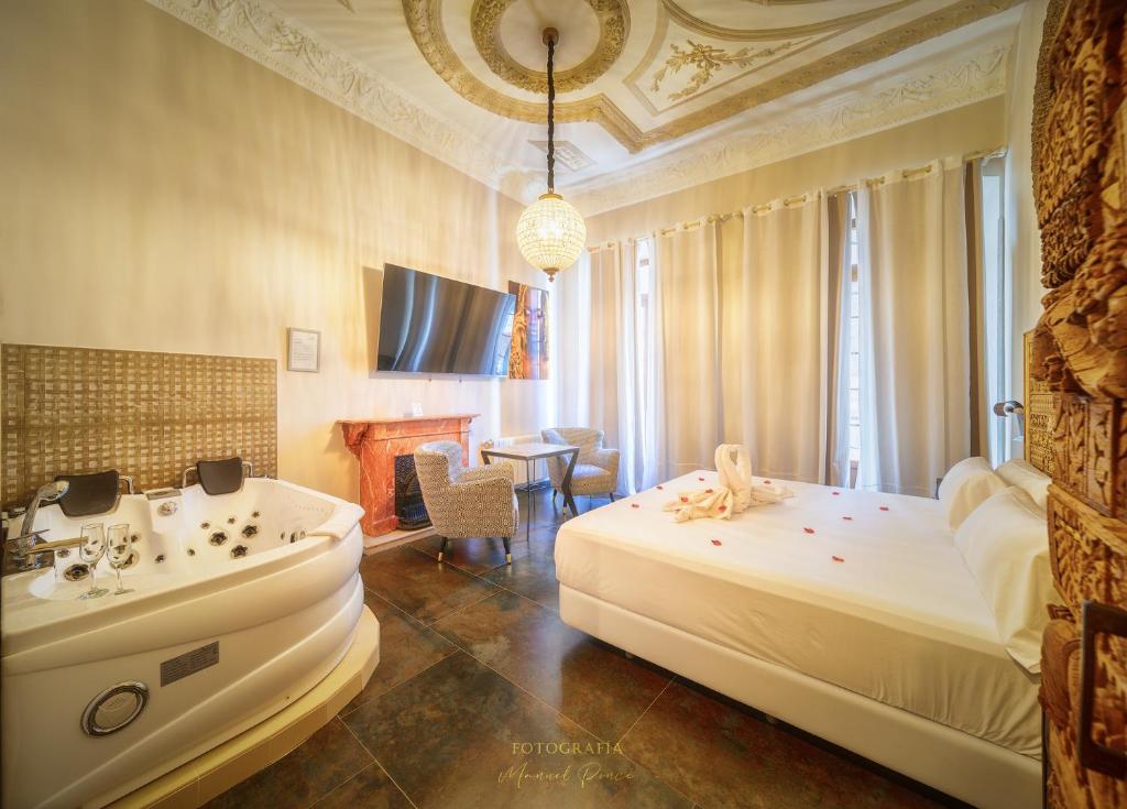Säng eller sängar i ett rum på Hotel Boutique Adealba Badajoz