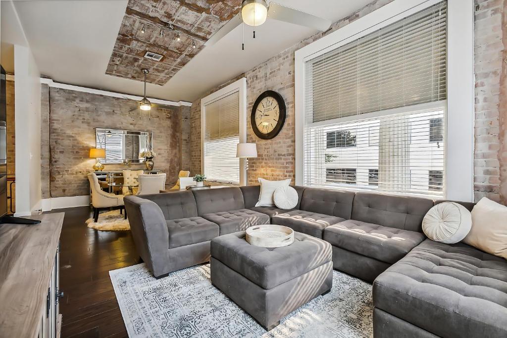 a living room with a couch and a table at Spacious Downtown New Orleans Vacation Rental in New Orleans